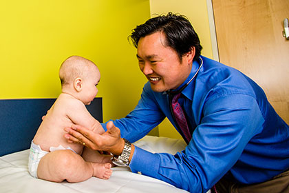doctor examining a baby