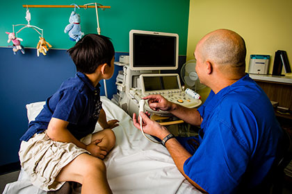 doctor showing child medical equipment